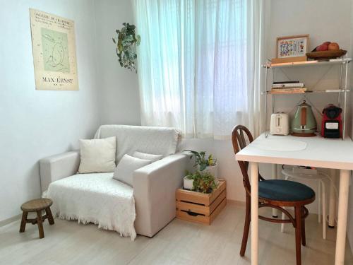 a living room with a chair and a table at Gold Stream House in Seoul