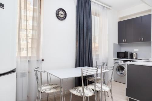 a kitchen with a table and chairs in a room at Bright 2BR Residence Central Yerevan in Yerevan
