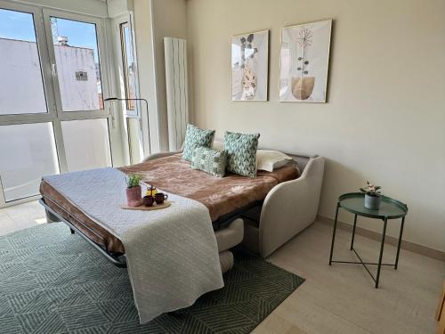 a room with a couch and a table in a room at Apartamento Cimadevilla Plaza in Oviedo