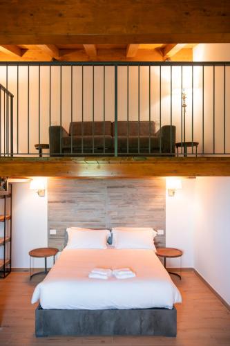 a bedroom with a bed and a loft at Tenuta Marella in Santa Maria di Galeria