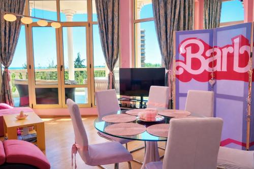 a dining room with a table and chairs at Barbie-Themed 3BDR Penthouse Near The Beach, Nessebar in Nesebar
