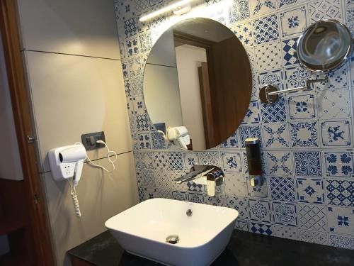 a bathroom with a sink and a mirror at SKY PENTA RESIDENCY in Iritti