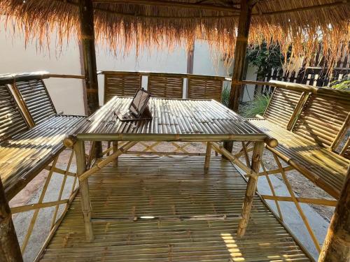 a wooden table with a laptop sitting on a deck at TRANQUILITY Resort in Nong Prue