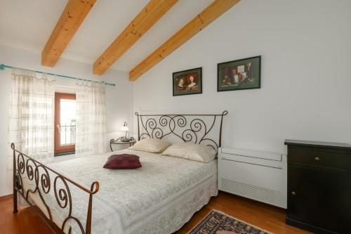 a bedroom with a bed with a white comforter at Apartment Seafront Mia in Umag