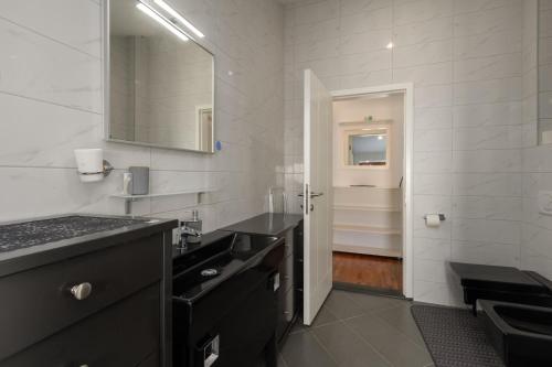 a bathroom with a black sink and a mirror at Apartment Seafront Mia in Umag