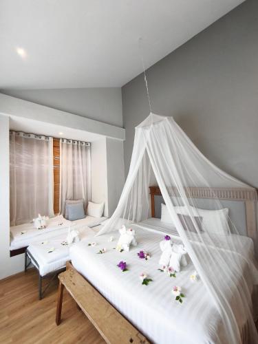 a bedroom with a bed with teddy bears on it at Silan Residence, Koh Phangan - An authentic village experience in Chaloklum