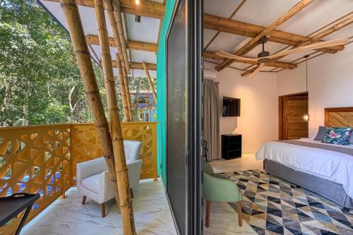 a bedroom with a bed and a room with a window at Dos Olas Ocean-Inspired Luxury Villa in Quepos