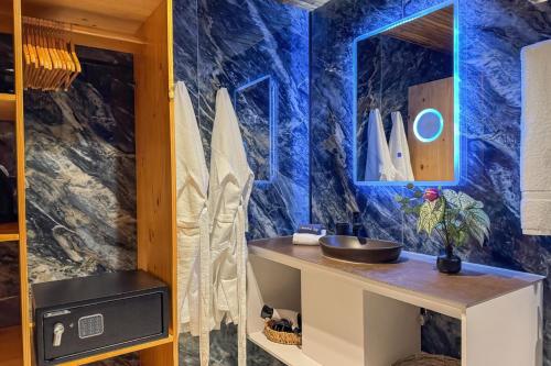 a bathroom with a sink and a blue wall at Dos Olas Ocean-Inspired Luxury Villa in Quepos