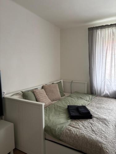 a bed with a black bag on it in a bedroom at Apartmán pod Hradem in Most