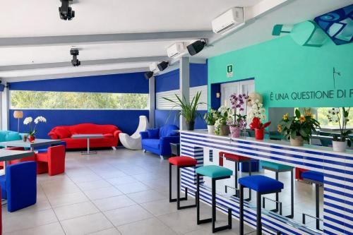 a bar with colorful stools in a restaurant at Hotiday Sorrento Capo in Sorrento