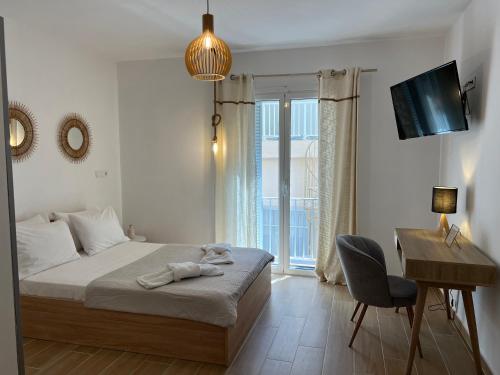 a bedroom with a bed and a desk and a chair at Calm Joy & J - New Bird in Ermoupoli