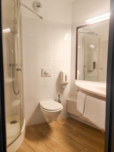 a bathroom with a toilet and a sink and a shower at B&B HOTEL Rodez Bourran in Rodez