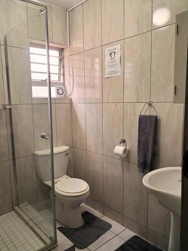 a bathroom with a toilet and a sink at Just Property Zululand in Richards Bay