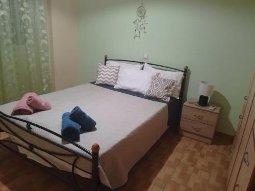 a bedroom with a bed with two hats on it at Aellia-Beautiful apartment in Vathi Samos in Vathý