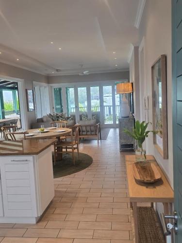 a kitchen and living room with a table and chairs at Eden Island Gem in Eden Island