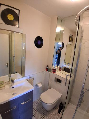 a bathroom with a toilet and a sink and a mirror at Bedroom in Blanchardstown in Blanchardstown