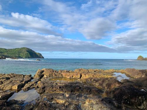 a view of the ocean with rocks in the water at L'Astrolabe - Private Beach in Baras