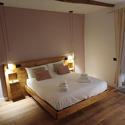 a bedroom with a large bed with two towels on it at Palazzo Bottino in Bolsena