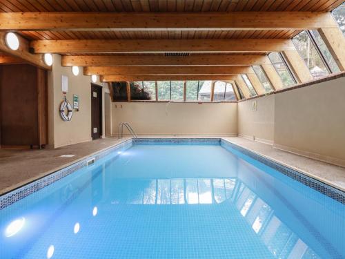 a swimming pool with a skylight in a house at Watermouth Castle, Harbour Apartment in Ilfracombe