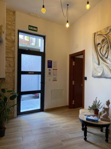 a lobby with a door and a table in front of it at Thor Hostal Boutique in Alicante