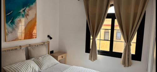 a bedroom with a bed and a window at CASA LUKASA 39c in Costa Calma