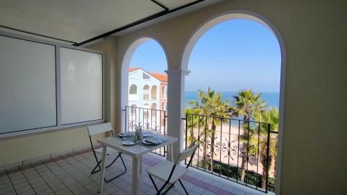 a balcony with a table and a view of the ocean at Monolocale DIRETTAMENTE SUL MARE cod 509 in Porto Recanati