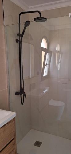 a bathroom with a shower with a toilet and a sink at CASA LUKASA 39c in Costa Calma
