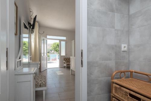 a hallway of a home with a sink and a mirror at Apartments Coce in Trogir