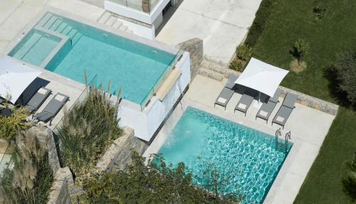 an overhead view of a swimming pool with chairs at Arbora Olea Luxury Villas in Skaleta