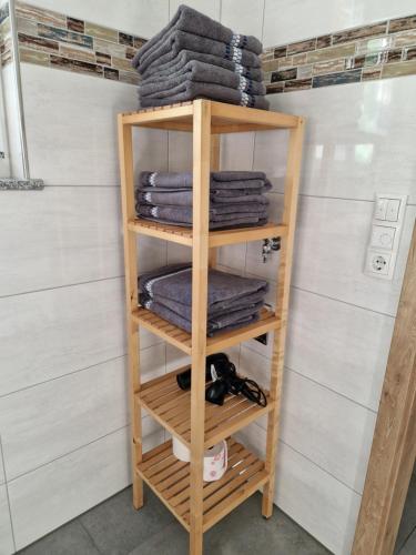 a wooden towel rack in a bathroom with towels at Gästehaus Martha in Rust