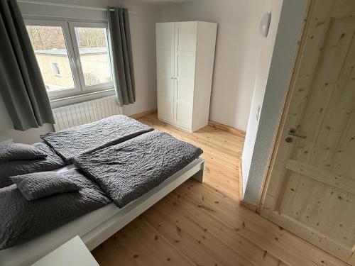 a bedroom with a bed and a window and a door at Ferienhaus Halbritter Pouch 2 in Pouch