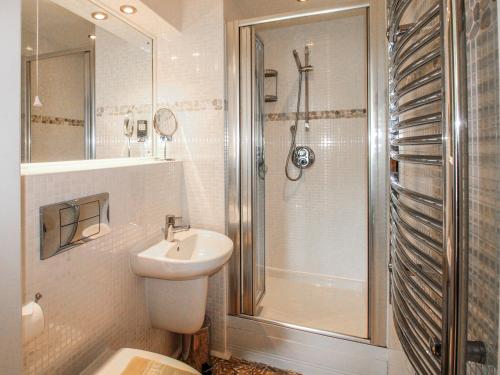 a white bathroom with a sink and a shower at 7 Ocean's Edge in Kingsbridge