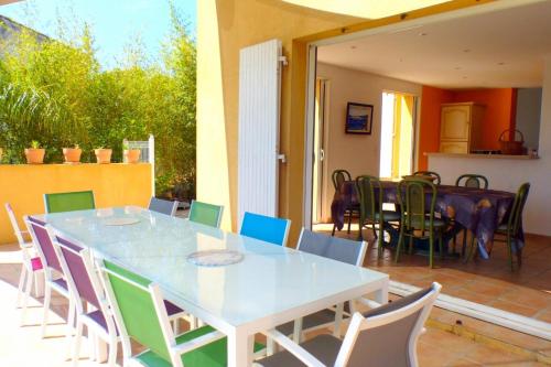 a white table and chairs on a patio at Spacious and bright house with swimming pool in Bandol