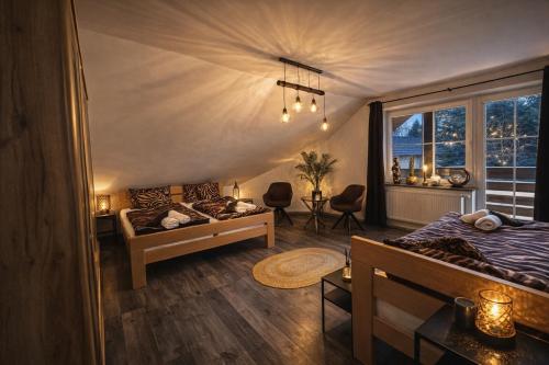 a bedroom with a bed and a couch and a window at Fleiš Residence villa - jacuzzi included in Most