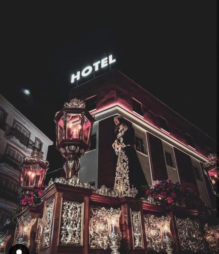 a hotel sign on top of a building at night at Hotel Paula Films Collection in Mérida