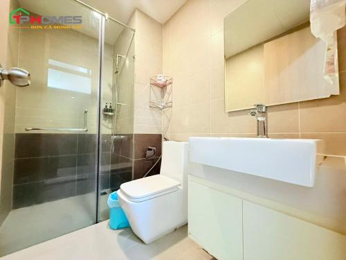 a bathroom with a shower and a toilet and a sink at TPHomes 12 - The Sun Avenue in Ho Chi Minh City