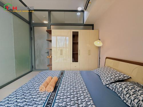 a bedroom with a bed with two towels on it at TPHomes 12 - The Sun Avenue in Ho Chi Minh City
