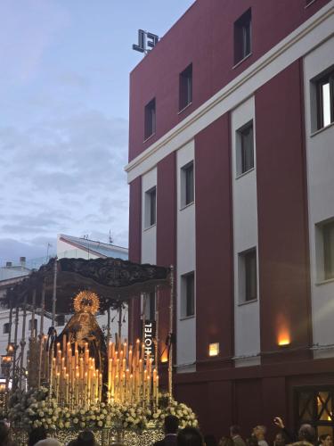 a group of people standing in front of a building with candles at Hotel Paula Films Collection in Mérida