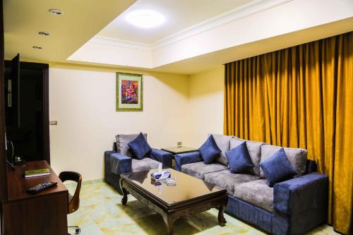 a living room with a couch and a coffee table at Qaser Al-Sultan Hotel Suites in Amman