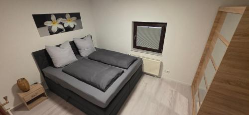 a couch in a room with a window at Apartment Me-Time in Bad Salzungen