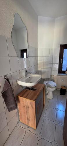 a bathroom with a sink and a toilet at Apartment Me-Time in Bad Salzungen