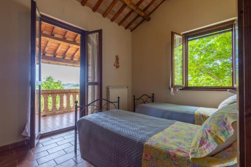 a bedroom with two beds and a balcony at Agriturismo Terralieta in Roseto degli Abruzzi