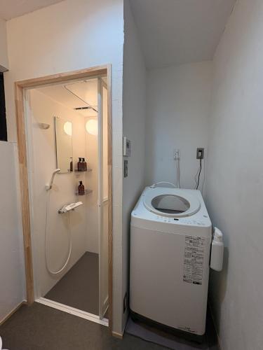 a small bathroom with a toilet and a shower at 城北ノイエ by mooi in Aizuwakamatsu