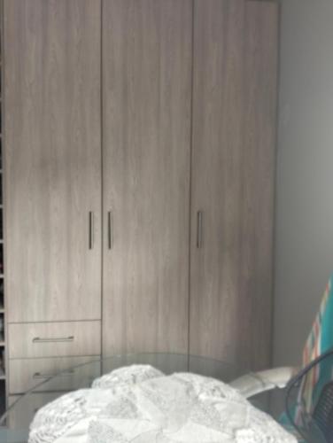 a bedroom with wooden cabinets and a glass table at Goodman's Guest home in Nelspruit