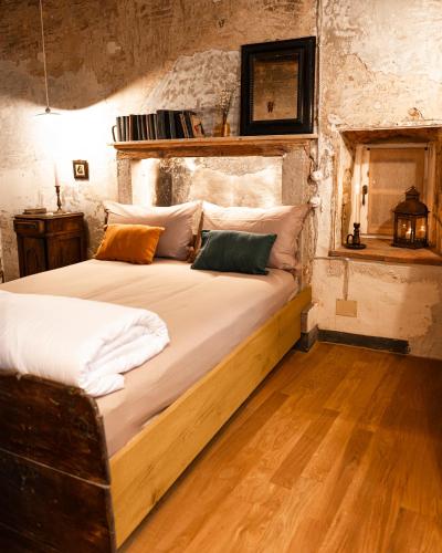 a bedroom with a large bed with white sheets and pillows at Relais il Convento in Palazzago