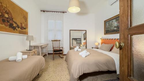 a bedroom with two beds with towels on them at Veranda Liberty, luxury apartment in La Spezia