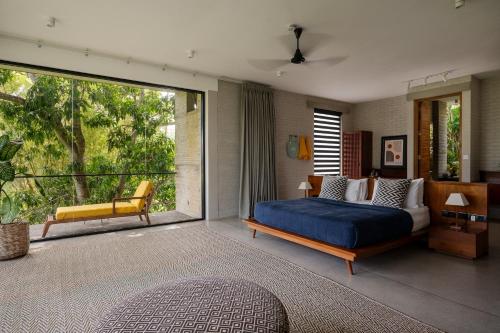 a bedroom with a bed and a large window at Villa Alba - Ahangama in Ahangama