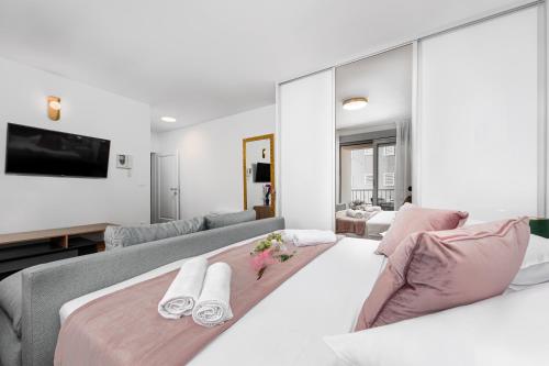 a living room with two beds and a tv at Vila Pivac in Makarska
