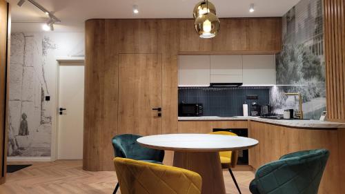 a kitchen and dining room with a table and chairs at LEO Apartman in Veszprém