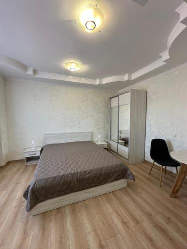 a bedroom with a bed and a table and chairs at Апартаменти Пасаж in Skhidnitsa